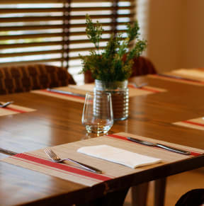 Long Wooden Table with Chairs at Hampton Apartments in Clearwater, FL 33759