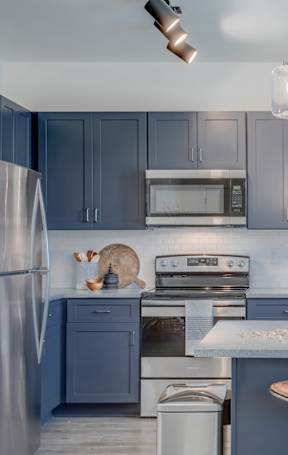 an open kitchen with a granite counter top and stools