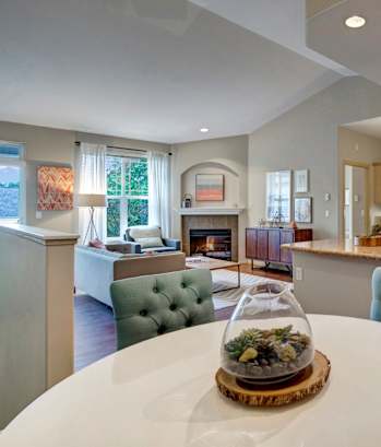 A modern kitchen with a dining table in the middle.