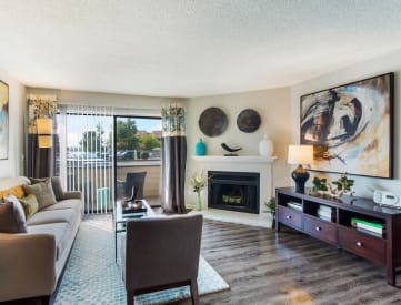 Living Room with Patio and Fireplace at Deer Crest Apartments, 80020
