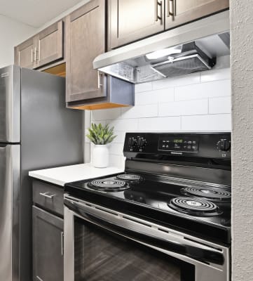 a kitchen with stainless steel appliances and a wooden floor