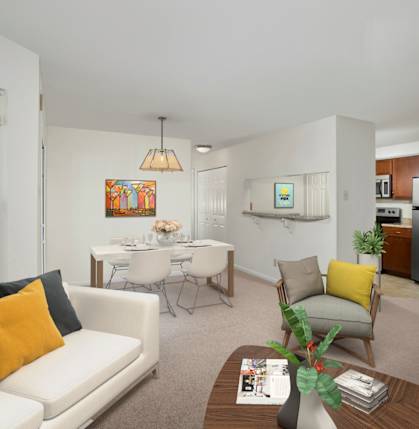A living room with a white couch, a coffee table, and a dining table.
