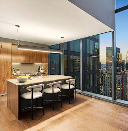 A modern kitchen with a view of the city skyline.