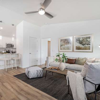 our apartments offer a living room with a couch a coffee table and a kitchen with a bar