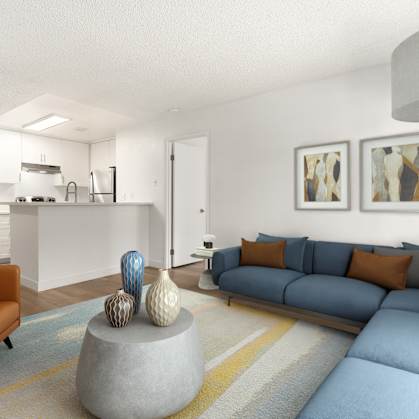 A living room with a grey couch and a grey coffee table with a blue couch and orange pillows.