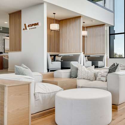 a living room filled with furniture and large windows