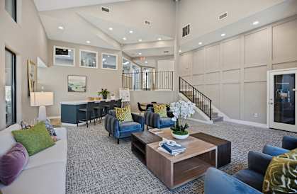a living room with furniture and a staircase