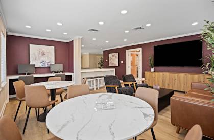 A modern dining room with a marble table and chairs.