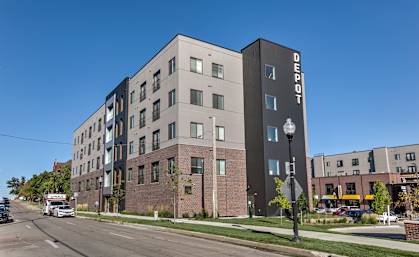 A modern apartment building with the name "Bedrock" on the side.