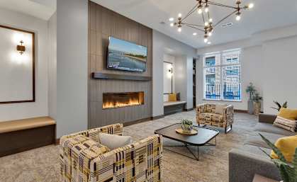 A modern living room with a fireplace and a television mounted above it.