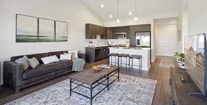 A modern living room with a grey couch and a coffee table.