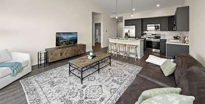 A modern living room with a brown couch and a coffee table.