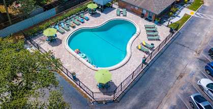 Watermarc aerial view of a swimming pool with lounge chairs and umbrellas