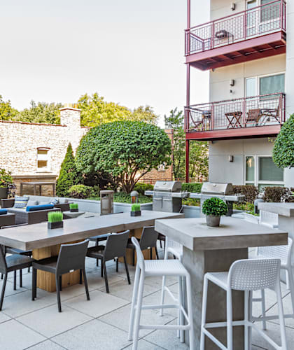 A patio with a table and chairs is set up outside a building.