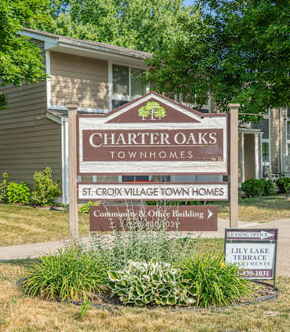 the sign in front of a charters oaks townhomes