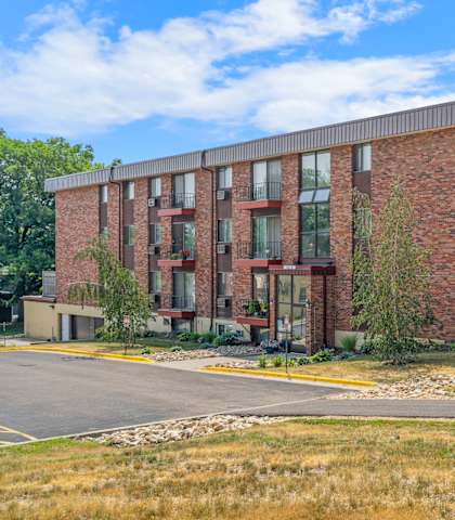 a brick apartment building with a road in front of it