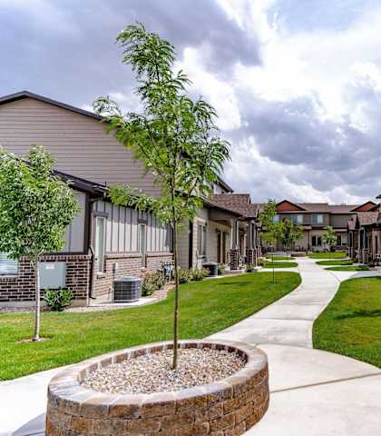 a sidewalk leading to a row of houses at Arcadia Townhomes, Roy, UT