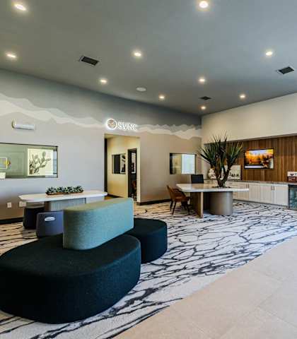a lobby with couches and chairs and a table
