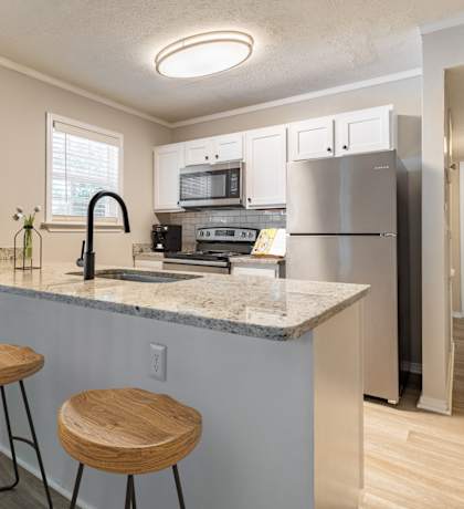 a kitchen with a breakfast bar and stools