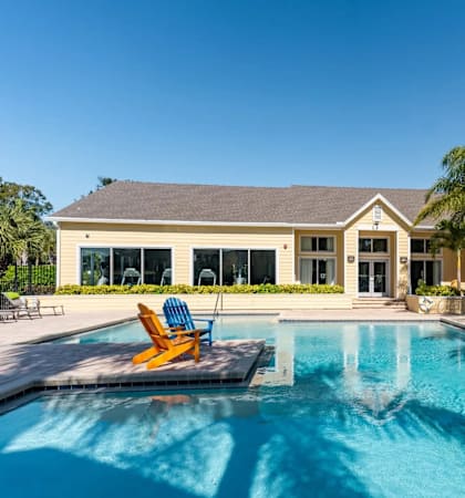 A house with a pool in front of it.