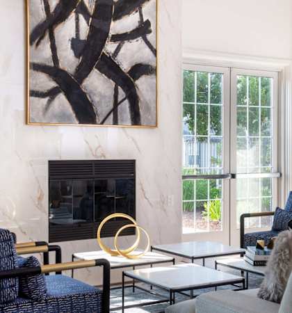A leasing office with a fireplace and a painting on the wall at Rosemeade Apartments, Roseville, CA