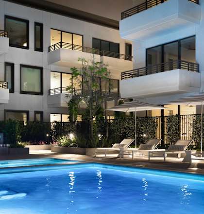 a swimming pool in front of a building with a pool