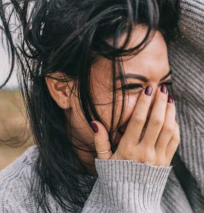 a woman covering her face with her hand
