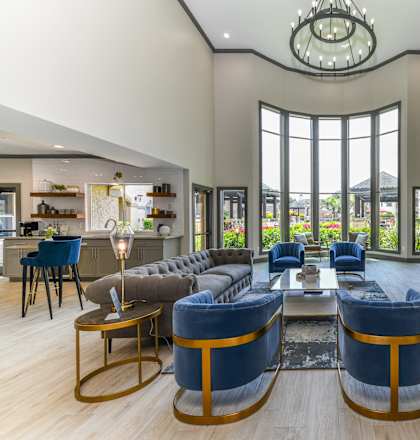 A modern living room with a stone fireplace and a large window.