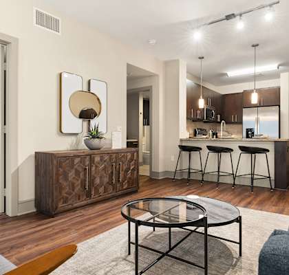 A modern living room with a wooden coffee table and a bar area.