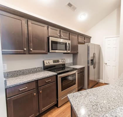 a kitchen with granite counter tops and stainless steel appliances