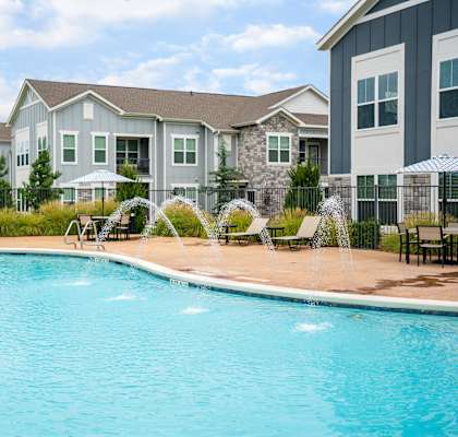 Large Resort-Style Pool with Lush Landscaping Surrounding