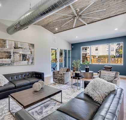 a living room with couches and chairs and a table