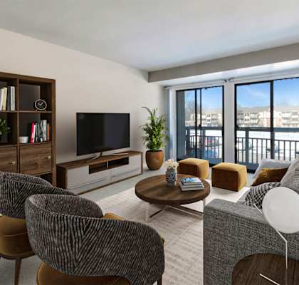 A living room with a grey couch, a coffee table, and a television.