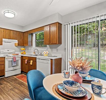 A kitchen with a white refrigerator and wooden cabinets.