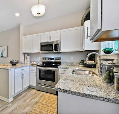 a kitchen with granite counter tops and stainless steel appliances