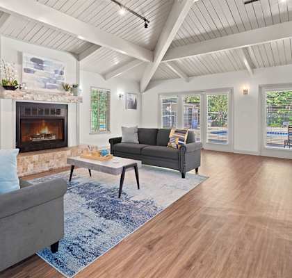 a living room with couches a coffee table and a fireplace