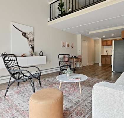 a living room with a white couch and chairs and a table at Fox Run Apartments, St. Charles, Illinois
