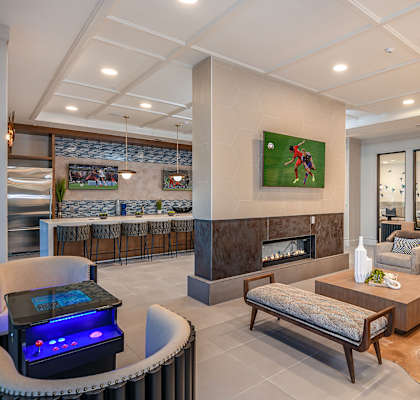 a resident clubhouse with a fireplace and tv  at The Exchange in St Petersburg, FL