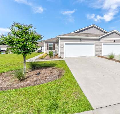 a house with a driveway and a garage door in front of it