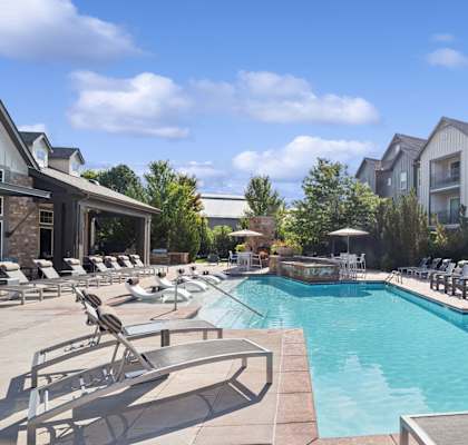 luxury swimming pool with sundeck lounging areas at Berkshire Aspen Grove apartments