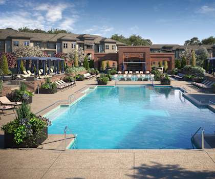 Turquoise outdoor pool surrounded by chairs and plants at 71 Tulsa Hills.