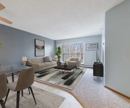 A living room with a glass table and grey chairs.