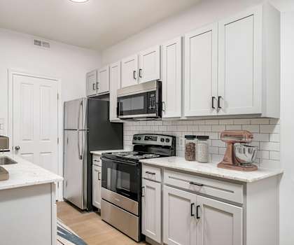 A kitchen with white cabinets and black appliances. at Prescott Place, Columbus, OH, 43235
