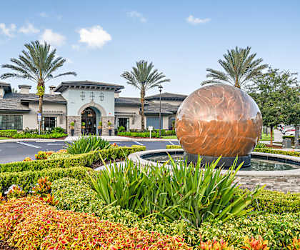 a building with a fountain and a sculpture in front of it
