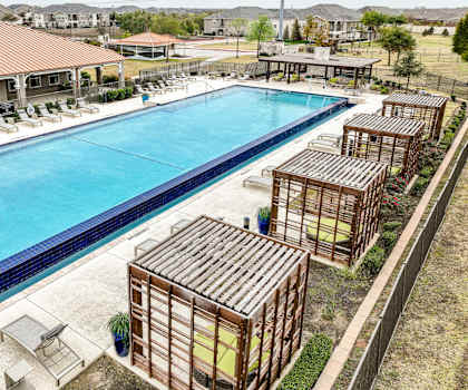 resort-inspired swimming pool with cabana lounging areas at Villages 3Eighty apartments