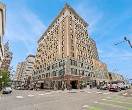 A street view of a city with a large building in the center.