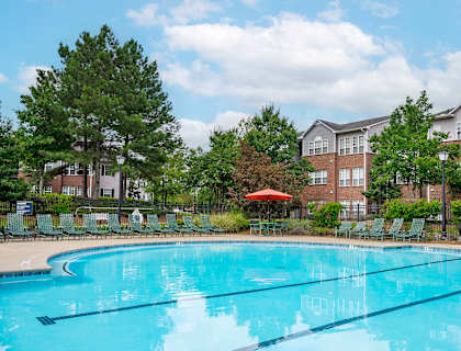 A swimming pool in front of apartment buildings.