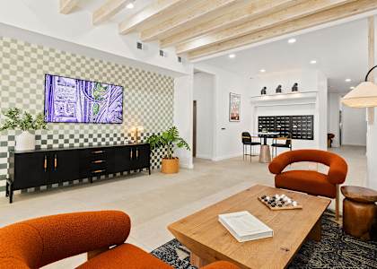 A living room with a television, a couch, and a coffee table.