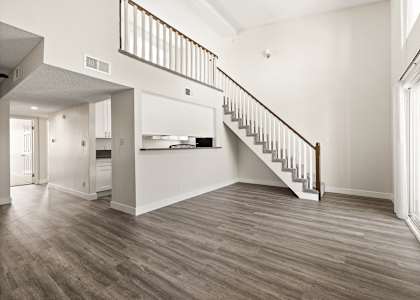 A large open space with a staircase leading to the upper floor.