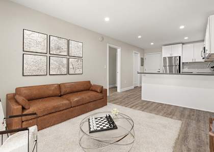 a living room with a couch and a glass coffee table
